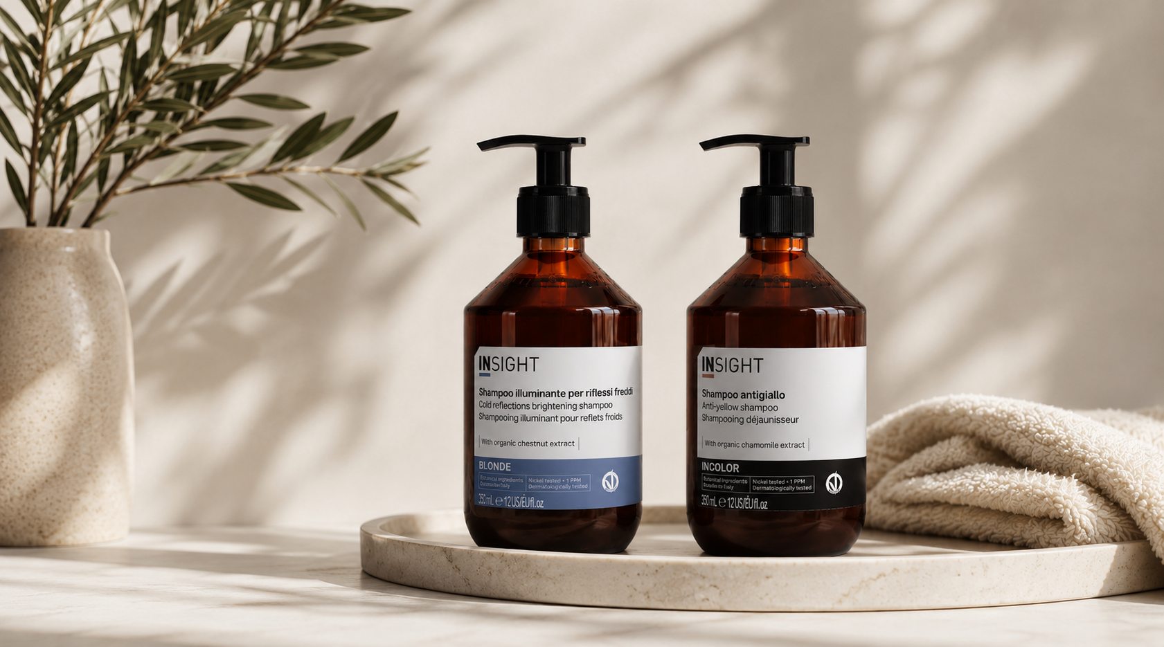 Insight Blonde Brightening Shampoo and Insight Incolor Anti-Yellow Shampoo on a neutral bathroom vanity, professional purple shampoos designed to neutralise brassy and yellow tones in blonde, highlighted and grey hair.